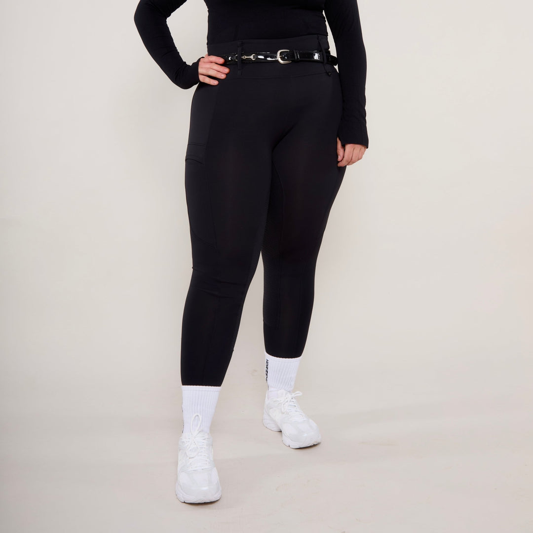 Front view showing a curvier lady in size XL  of HORZEHOODS® Black Luxe Equestrian Riding Leggings showcasing high-waist design